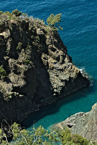 High angle view of rock formations by sea