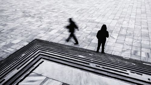 High angle view of people walking on footpath