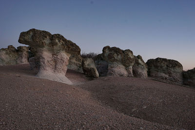 Rock formations in desert against clear sky