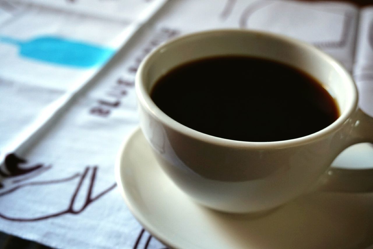 coffee cup, indoors, drink, coffee - drink, saucer, refreshment, coffee, cup, close-up, food and drink, table, still life, freshness, focus on foreground, spoon, tea, tea cup, selective focus, white color, high angle view