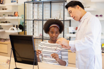 Girl consulting with eye doctor