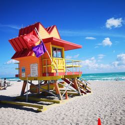 Lifeguard hut on beach against sky