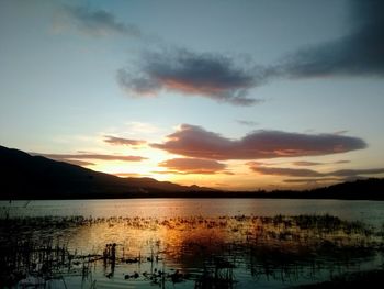 Scenic view of lake against sky during sunset