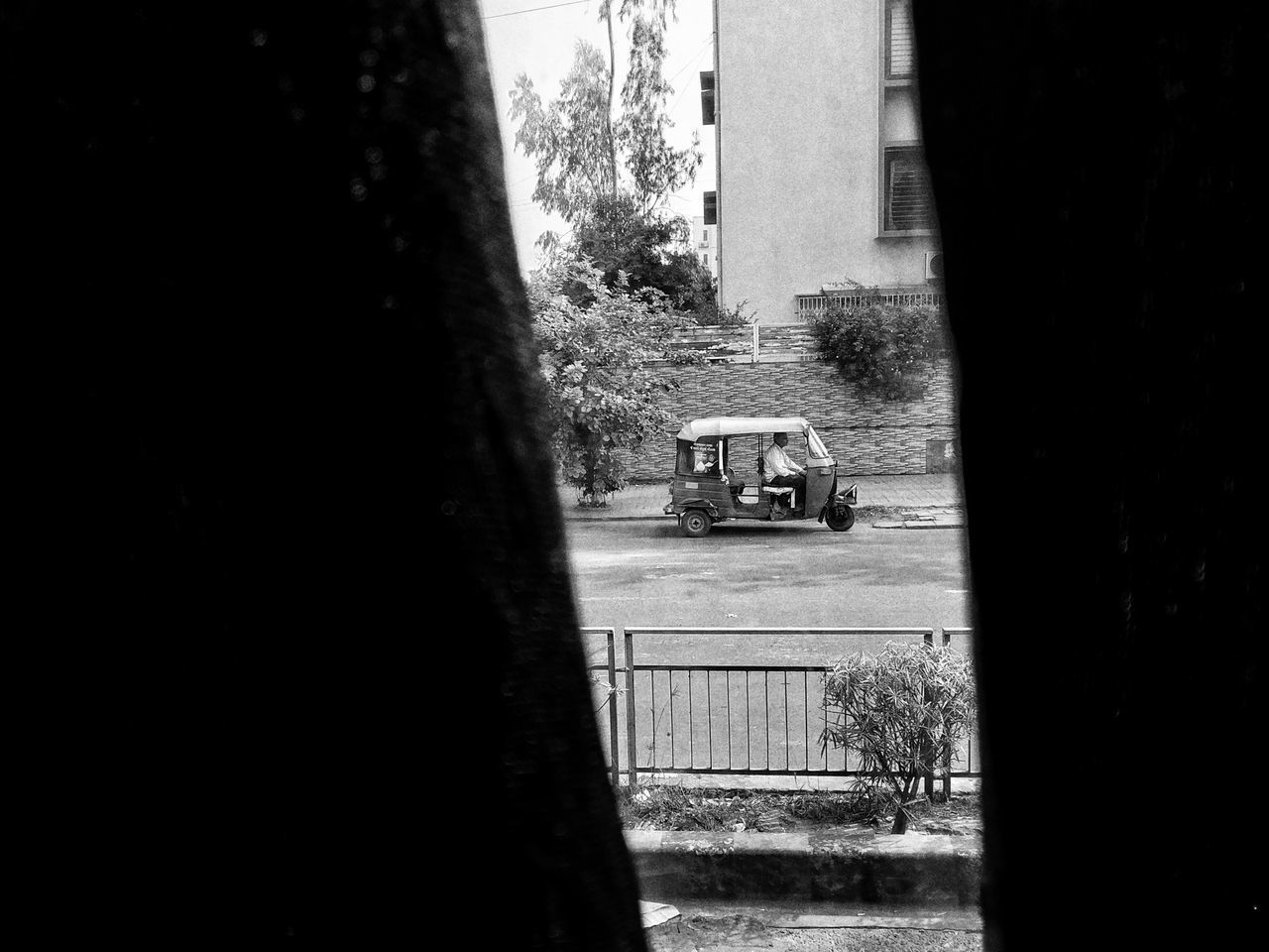 ROAD BY BUILDINGS SEEN FROM WINDOW