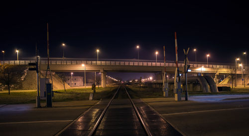Bridge over the railway track at night, illuminated bridge at night