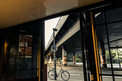 Bicycle by building in city against sky