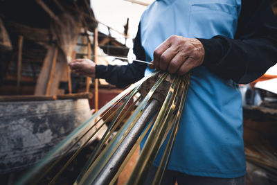 Hands weaving bamboo baskets at home,make a basket