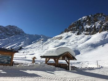 Scenic view of snowcapped mountains against clear blue sky