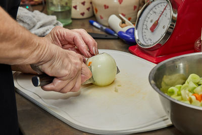 Cropped hand of man preparing food