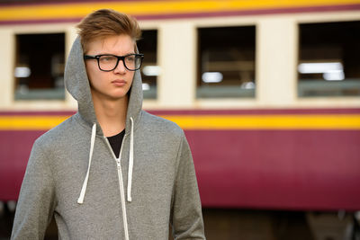 Portrait of young man standing outdoors