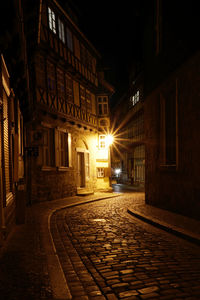 Street amidst illuminated buildings in town