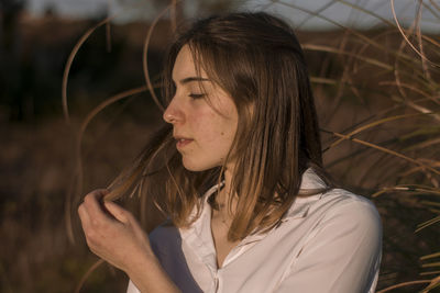 Close-up of beautiful woman standing by plants