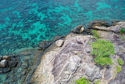 High angle view of rocks by sea