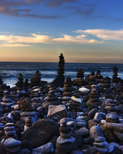 Rocks on beach during sunset