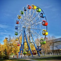 Low angle view of ferris wheel against sky