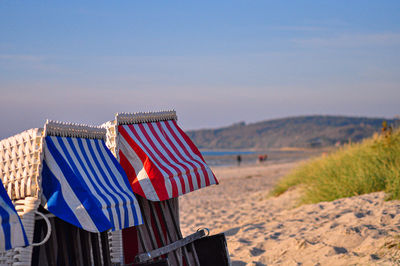 Clothes drying on beach against blue sky