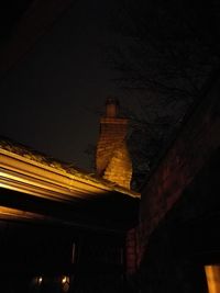 Low angle view of illuminated building against sky at night