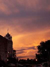 Buildings in city against sky during sunset