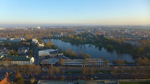 High angle view of river by buildings in city against sky