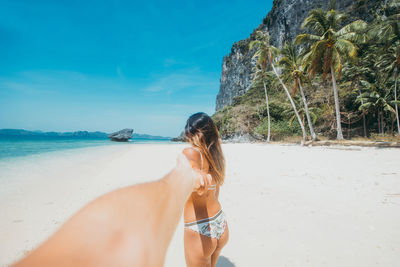 Full length of woman on beach against sky