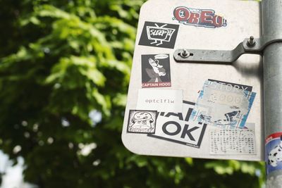 Close-up of information sign against trees