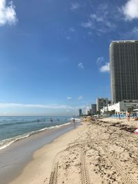 View of beach against cloudy sky
