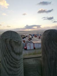 Man by sea against sky during sunset