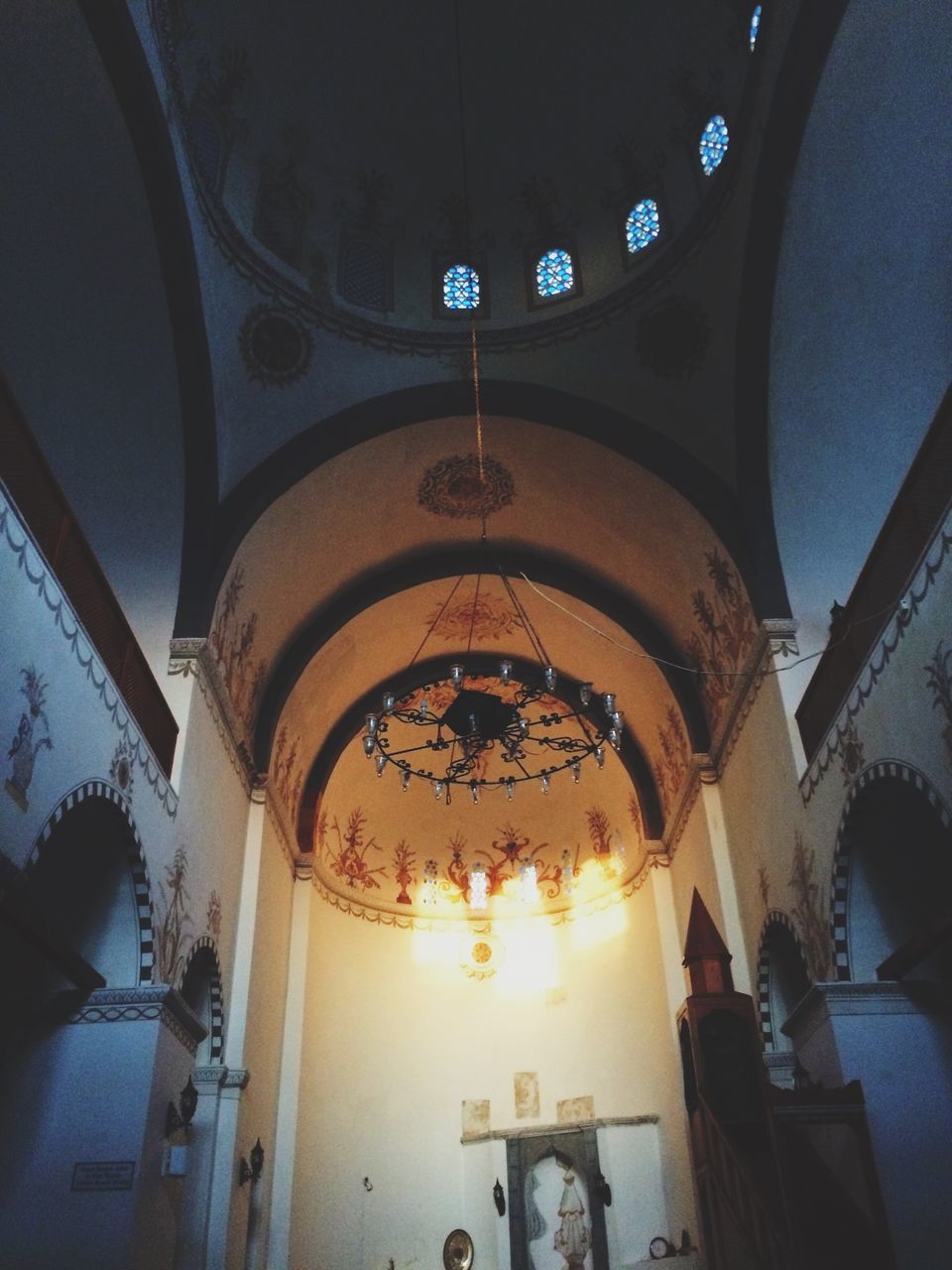 indoors, ceiling, low angle view, arch, hanging, architecture, no people, built structure, statue, illuminated, day