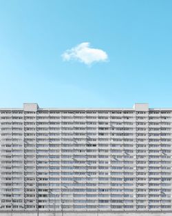 Low angle view of residential building against blue sky