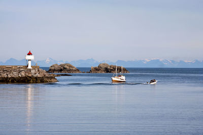Sailboats on sea against sky