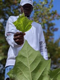 Portrait of man holding plant