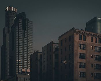 Low angle view of buildings against sky at dusk