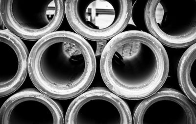 Cement drain pipes at a construction site in black and white. 