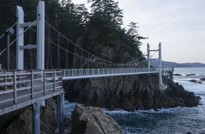 Bridge over sea against sky