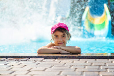 Portrait of girl wearing cap in swimming pool