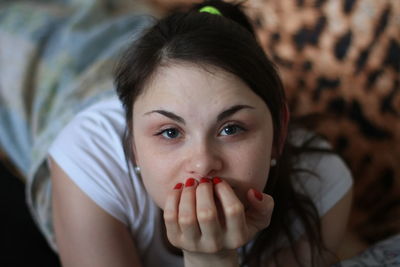 Close-up portrait of young woman at home