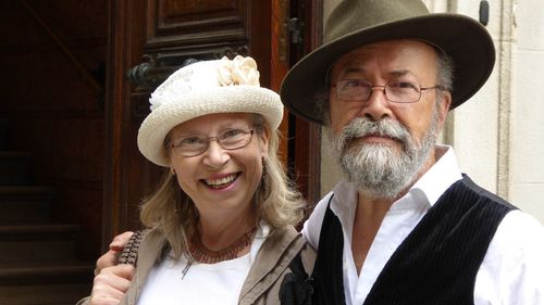 Portrait of mature man and woman outside house