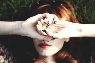 Directly above shot of woman covering face with hands