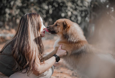 Side view of woman with dog
