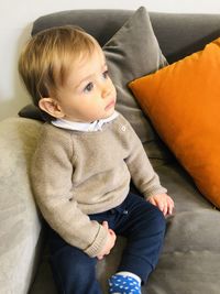 Young boy contemplating life on sofa