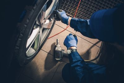 Low section of mechanic repairing car