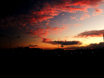 Silhouette of trees against dramatic sky