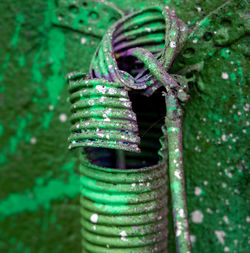 Close-up of electric wires on green graffiti background 