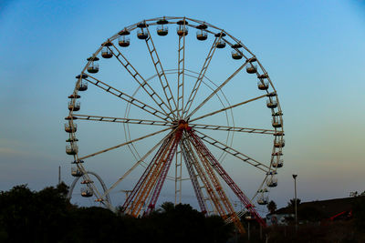 Low angle view of ferris wheel against sky