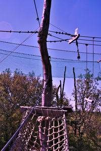 Barbed wire fence against clear blue sky