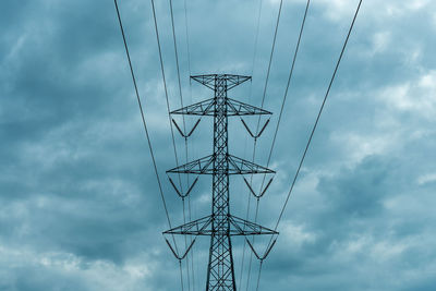 Low angle view of electricity pylon against sky