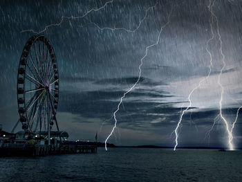 Ferris wheel against sky at night