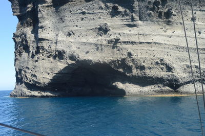 Scenic view of rock formation in sea against sky