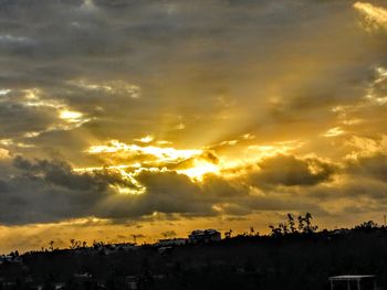 Silhouette buildings against sky during sunset