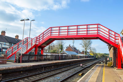 Train at railroad station against sky